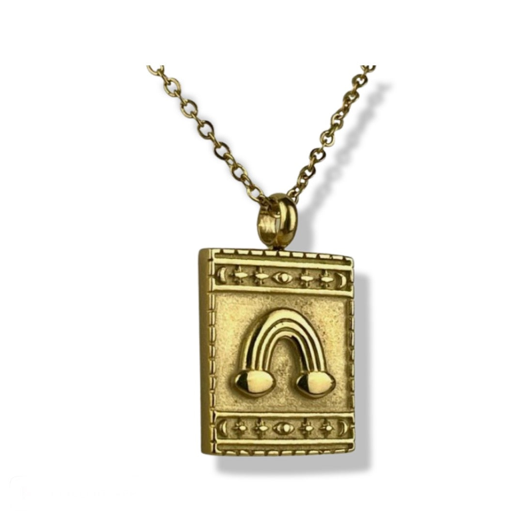 18K yellow gold plated stainless steel square pendant necklace with embossed rainbow detail surrounded by star and moon border. Necklace comes with an adjustable 20-22 inch chain.