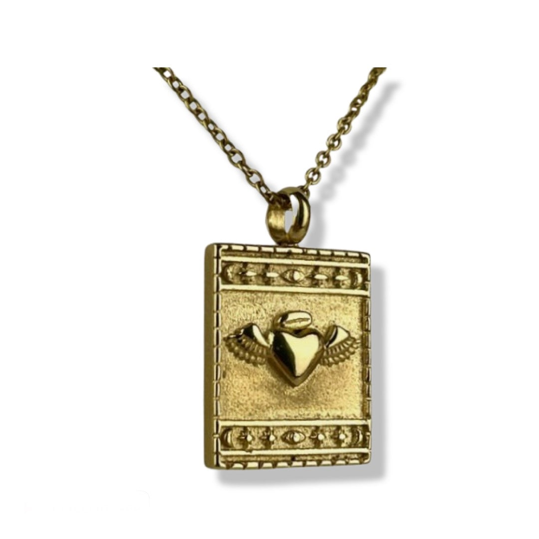 18K yellow gold plated stainless steel square pendant necklace with embossed heart detail surrounded by star and moon border. Necklace comes with an adjustable 20-22 inch chain.