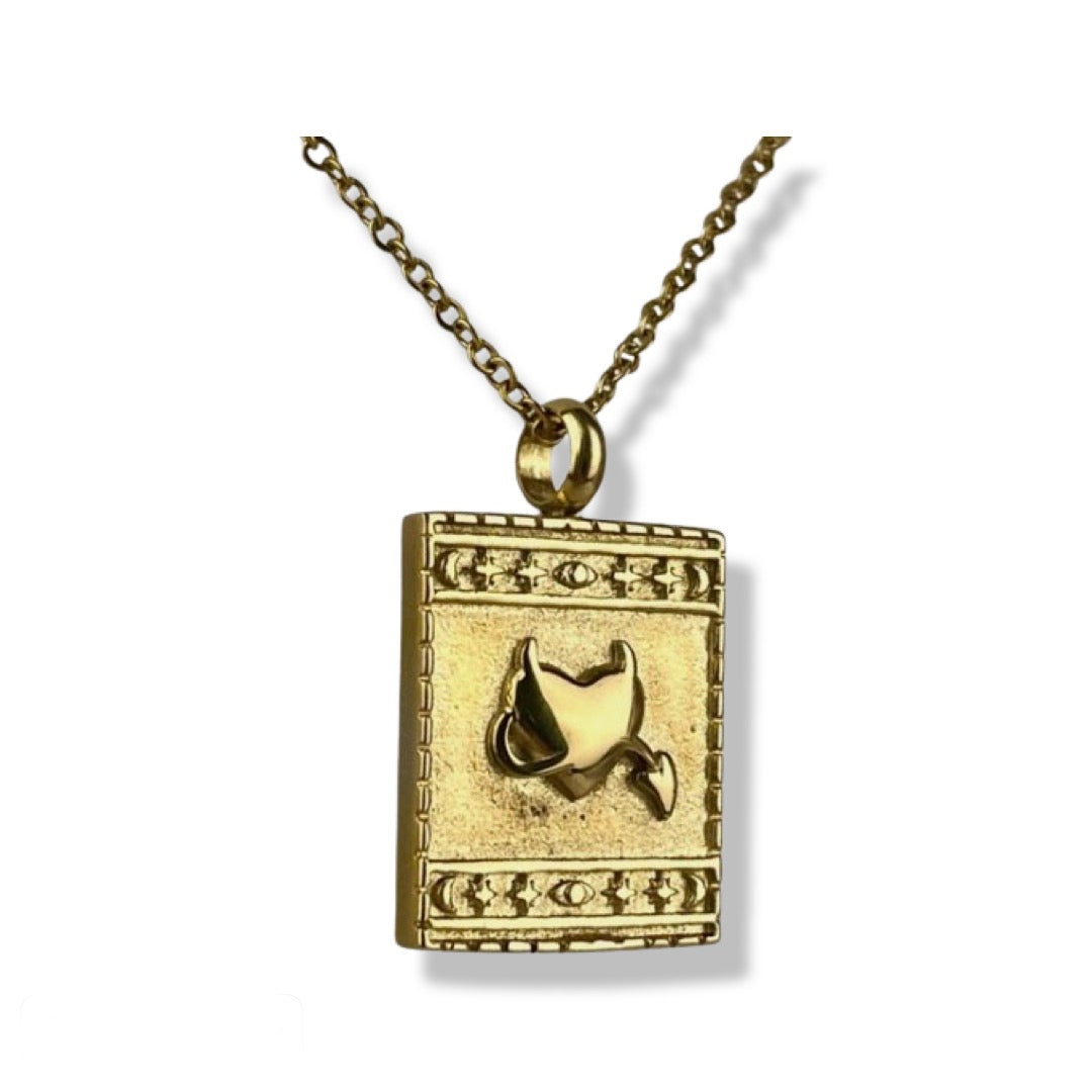 yellow gold square pendant necklace with embossed heart detail surrounded by star and moon border. 